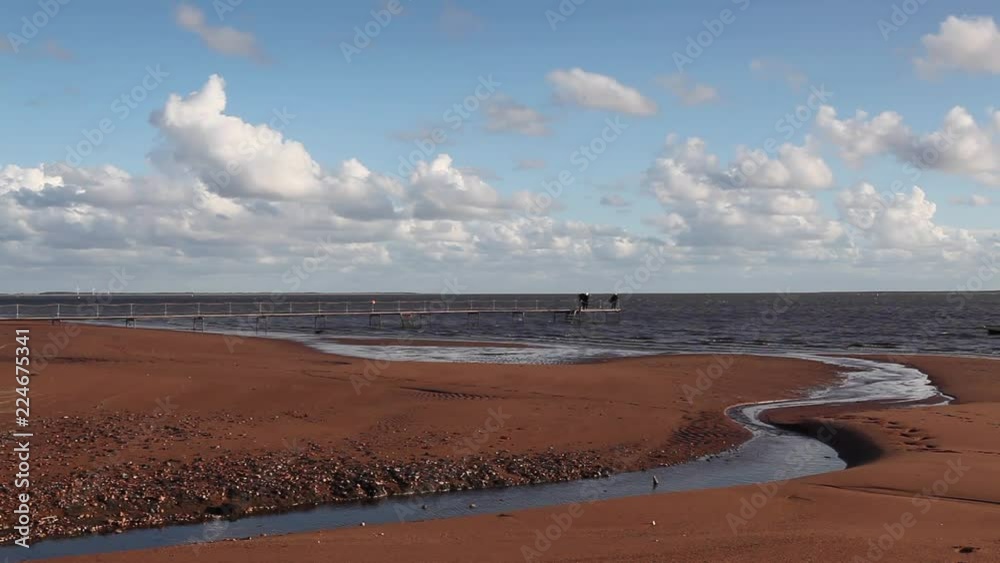 Sunset on the empty beach, Hjerting, Jutland, Denmark. Hjerting is a district of Esbjerg in southwest Jutland, Denmark Sunset on the empty beach, Hjerting, Jutland, Denmark. Hjerting is a district of Esbjerg in southwest Jutland, Denmark