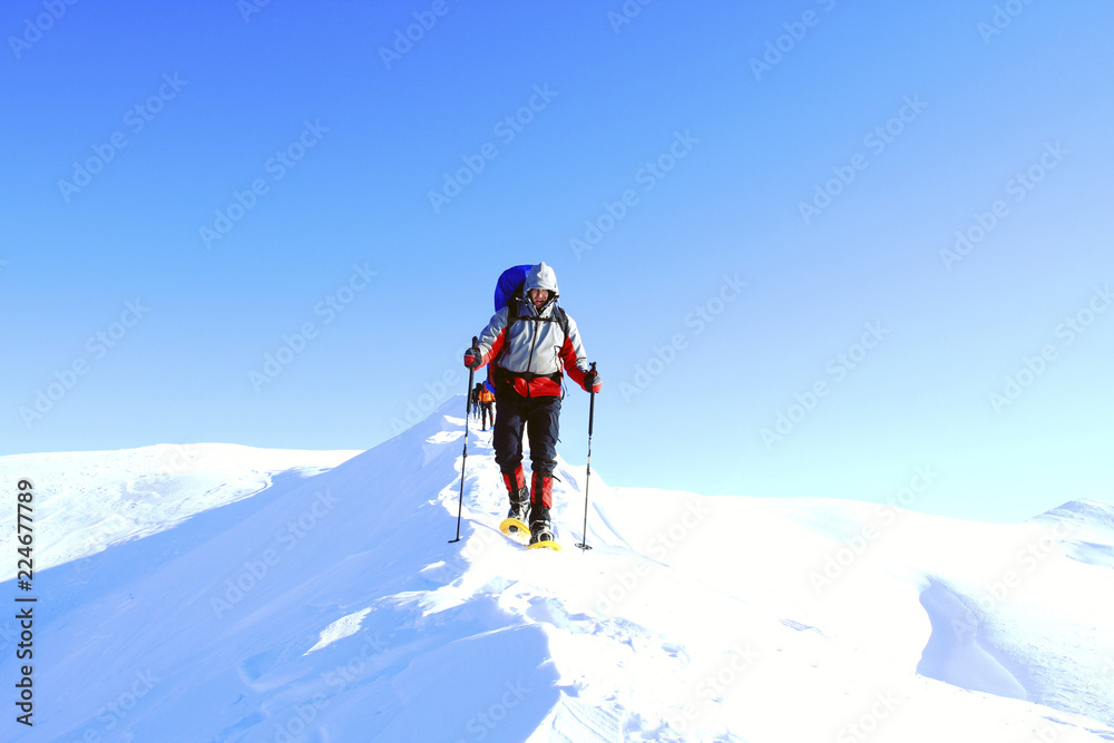 Winter hike in the mountains with a backpack and tent. Winter hike in the mountains with a backpack and tent.