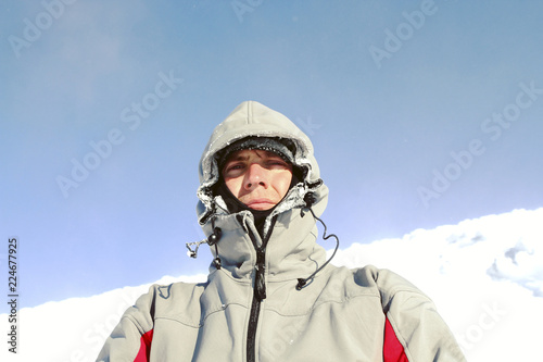 Winter hike in the mountains with a backpack and tent.