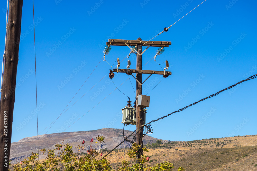 Power line voltage tower against blue sky