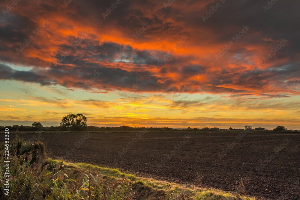 Dramatic Sunset over Ploughed Fields