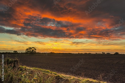 Dramatic Sunset over Ploughed Fields