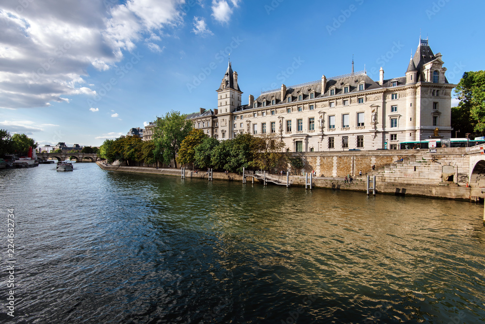 Paris, France - August 13, 2017. View of Conciergerie Palace and Prison on Cite island from Seine. Popular french landmark located on the west of the ile de la Cite, presently used for law courts.