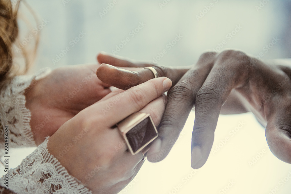 Fototapeta premium the bride puts on the ring the groom
