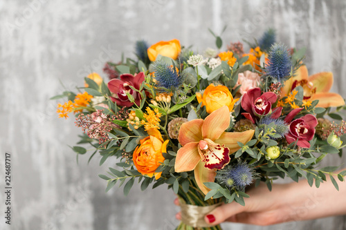 Fototapeta Naklejka Na Ścianę i Meble -  beautiful wedding bouquet of mixed flowers in woman hand.
