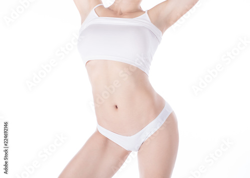 Female well groomed cropped fit body in white panties and top, isolated on white. © junky_jess