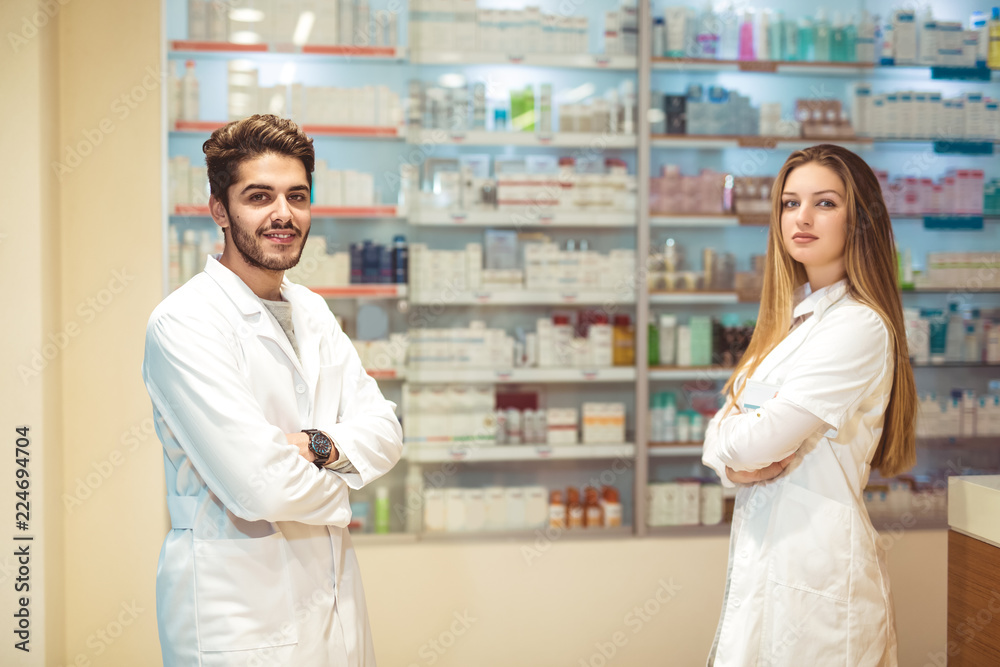 Female and male pharmacists in pharmacy