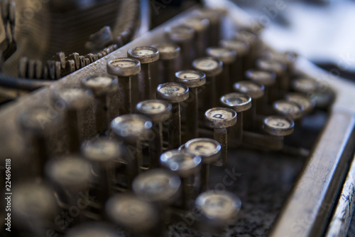 Close up view on an old dirty broken antique typewriter machine keys with Cyrillic symbols letters.