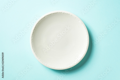 White plate on blue background, from above