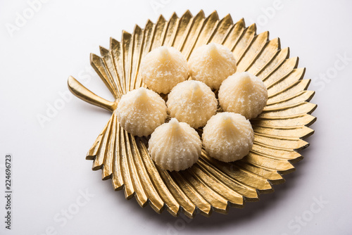 Sweet Modak made using coconut, khoya and sugar. Popular Maharashtrian recipe offered to lord Ganesha in Ganesh Festival. Served in a plate. Selective focus photo