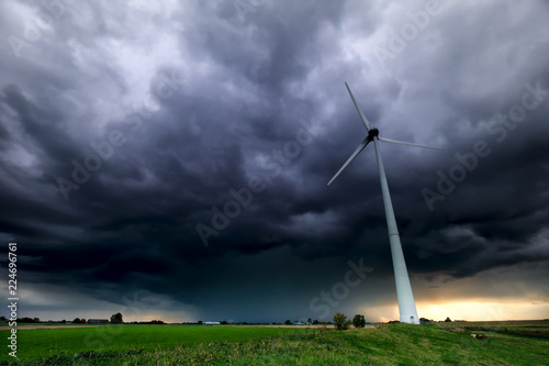 dramatic storm sky and wind turbine photo