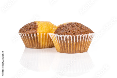 Group of two whole sweet fresh baked marble muffin isolated on white background photo