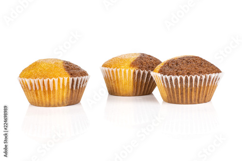 Group of three whole fresh baked marble muffin isolated on white background
