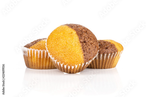 Group of three whole fresh baked marble muffin isolated on white background