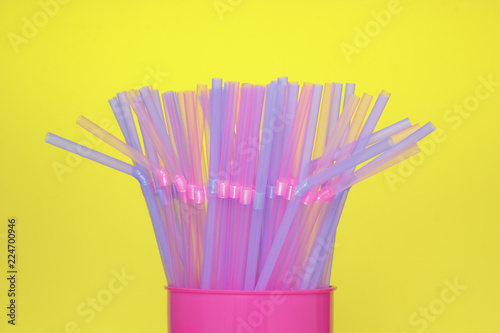 Drinking straws with yellow background.