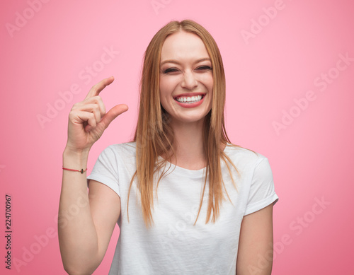 Mocking woman showing tiny size photo