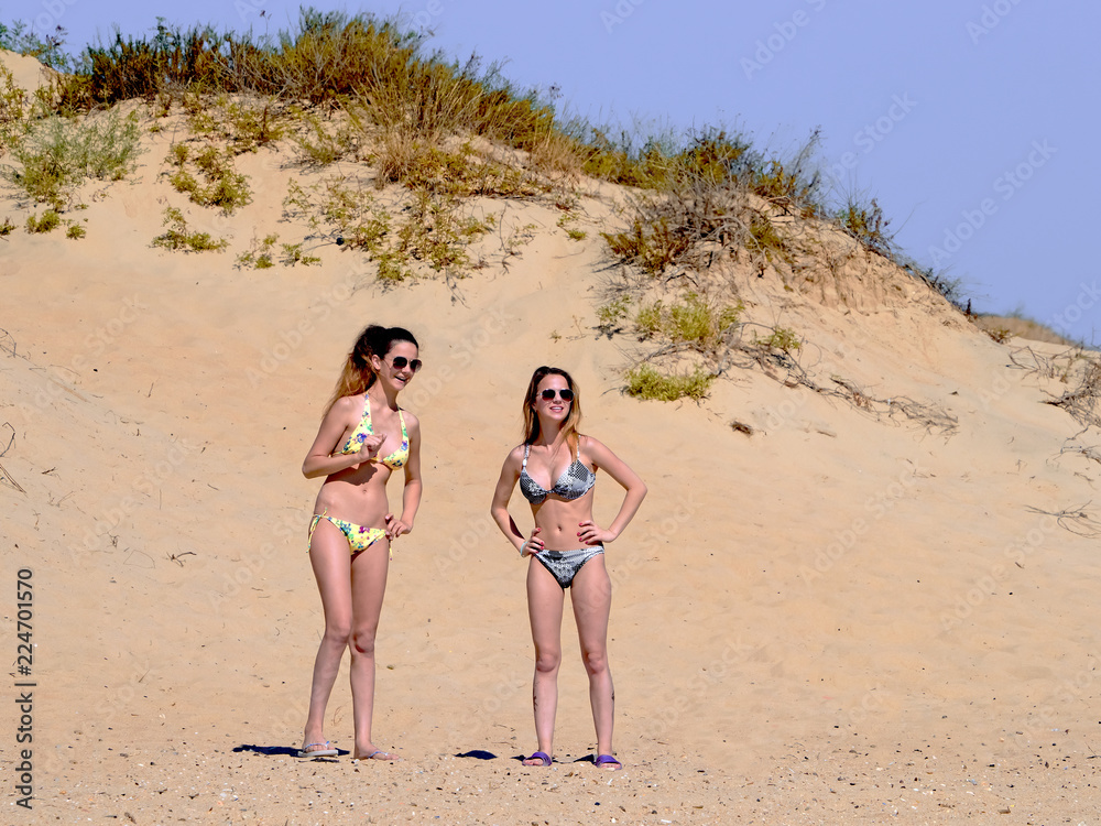 lifestyle outdoors portrait of two young happy sisters having fun enjoying summer holidays trip together walking relaxed and happy