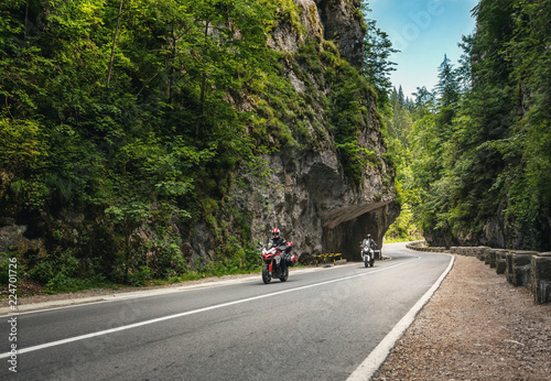 The mountain road runs between the rocks in the Romanian Carpathians