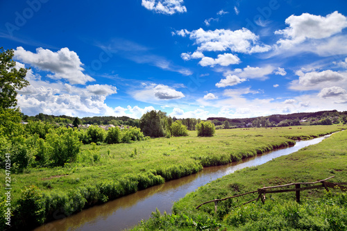Summer season river landscape. Picturesque Ukrainian village