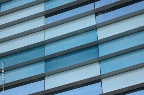 Glass building walls in the rays of sunset as background