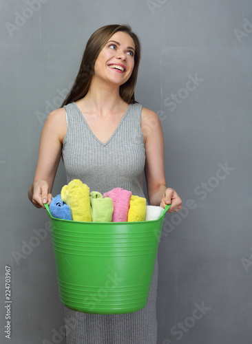 Laundry concept portrait with smiling woman holding big basket w