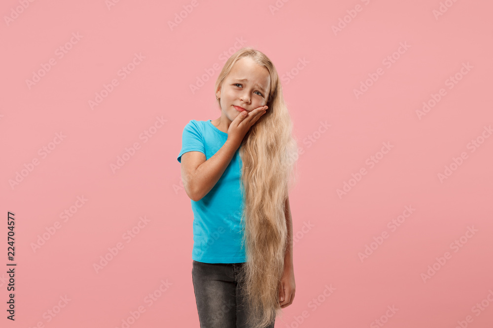 Young girl is having toothache. Pain concept. Young emotional teen. Human emotions, facial expression concept. Studio. Isolated on trendy color Young girl is having toothache. Pain concept. Young emotional teen. Human emotions, facial expression concept. Studio. Isolated on trendy color