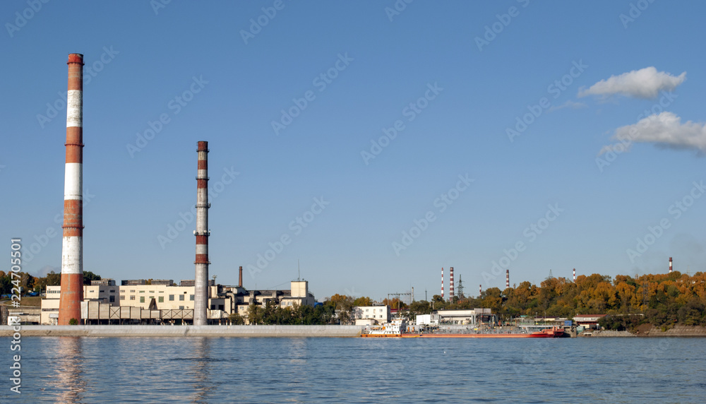 Industrial zone on the river. Chimney