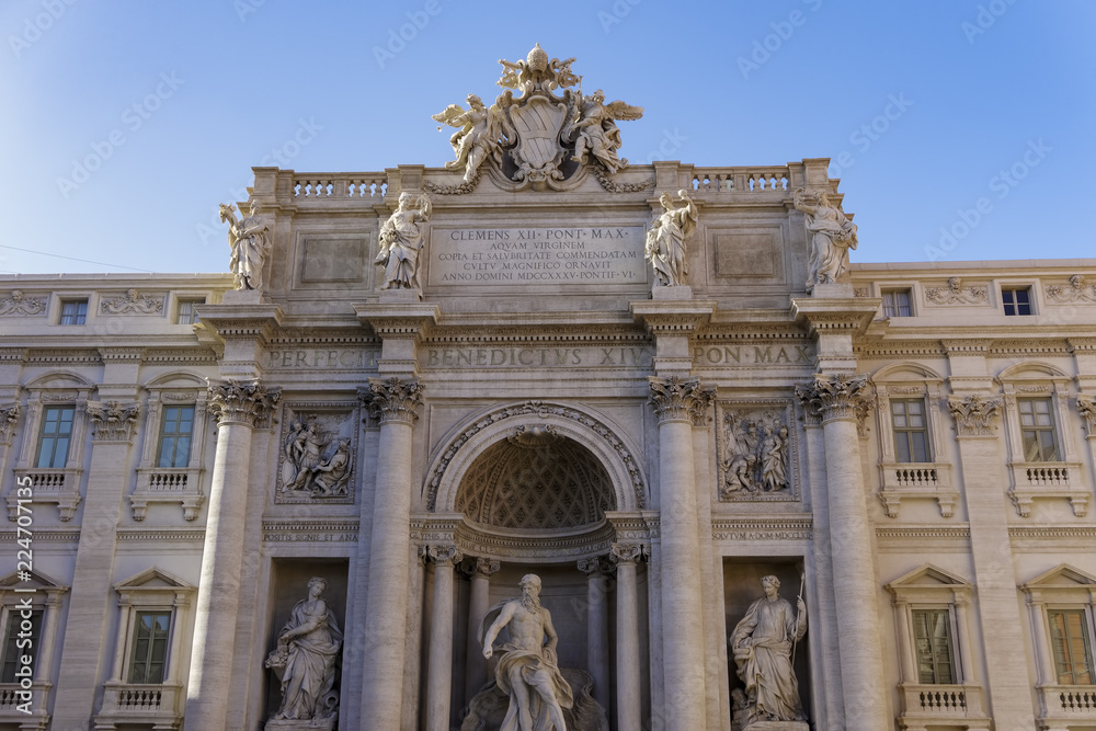 Rome, Italy restored Palazzo Poli Fontana Di Trevi facade day view without crowd. Renovated aqueduct-fed 1762 rococo famous fountain with sculpted figures and Latin inscriptions on triumphal arch.