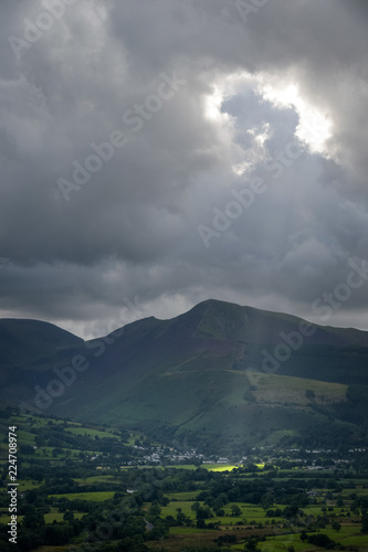 Beam of sunlight lights up the green and lush valley of Keswick England