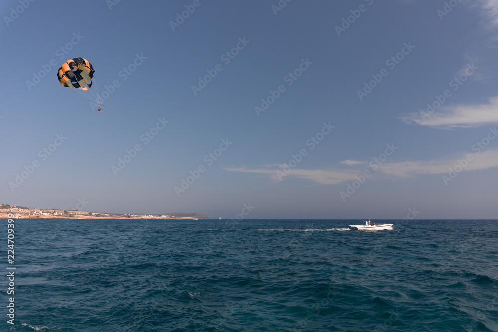 parasailing. the man is flying with a yellow parachute. close-up. parasailing. the man is flying with a yellow parachute. close-up.