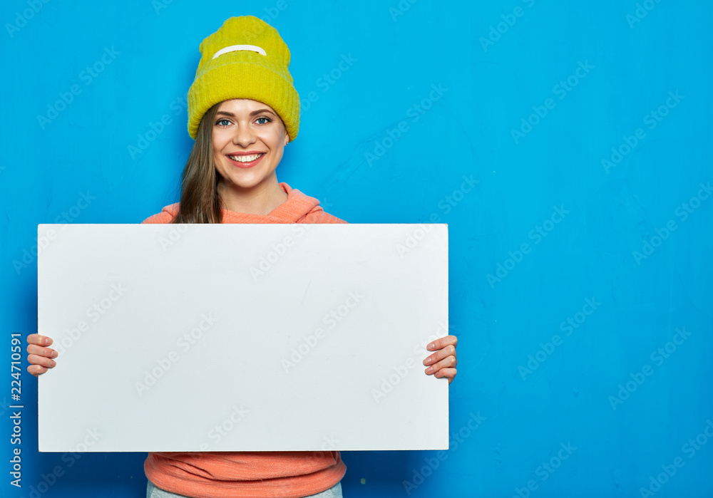 Modern woman holding blank white board. Blue background. Modern woman holding blank white board. Blue background.