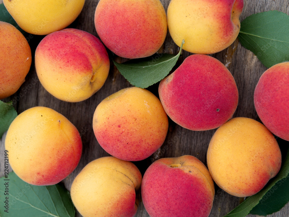 ripe apricots on a wooden table viewed from above close-up. organic, healthy and fresh fruit. horizontal top view ripe apricots on a wooden table viewed from above close-up. organic, healthy and fresh fruit. horizontal top view