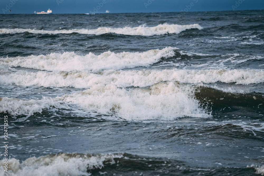 Stormy sea waves crashing against shore