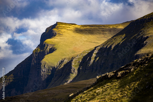 Green Mountain cliffs in Faroe islands on a sunny day