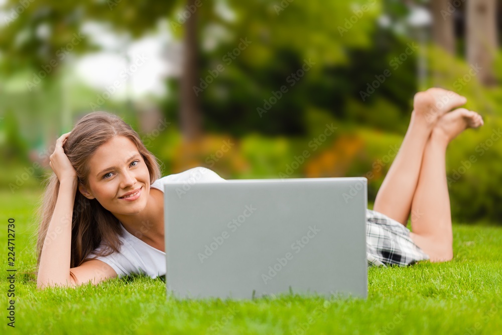Portrait of a Young Woman Using her Laptop in a Park Portrait of a Young Woman Using her Laptop in a Park