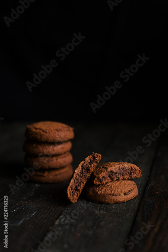 Oatmeal chocolate cookies on dark wooden table
