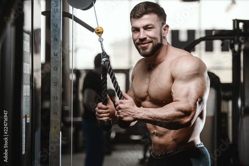 Brutal strong bodybuilder athletic men pumping up muscles with dumbbells