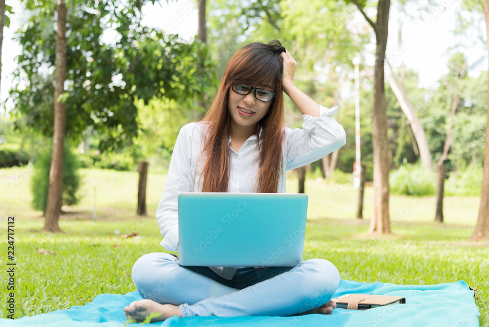 Girl freelance doing her job in the park. a difficult decision Girl freelance doing her job in the park. a difficult decision