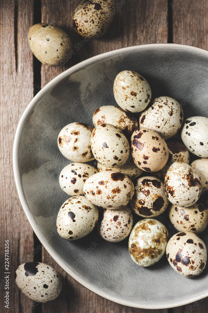 top view of raw organic quail eggs on plate wooden table top view of raw organic quail eggs on plate wooden table