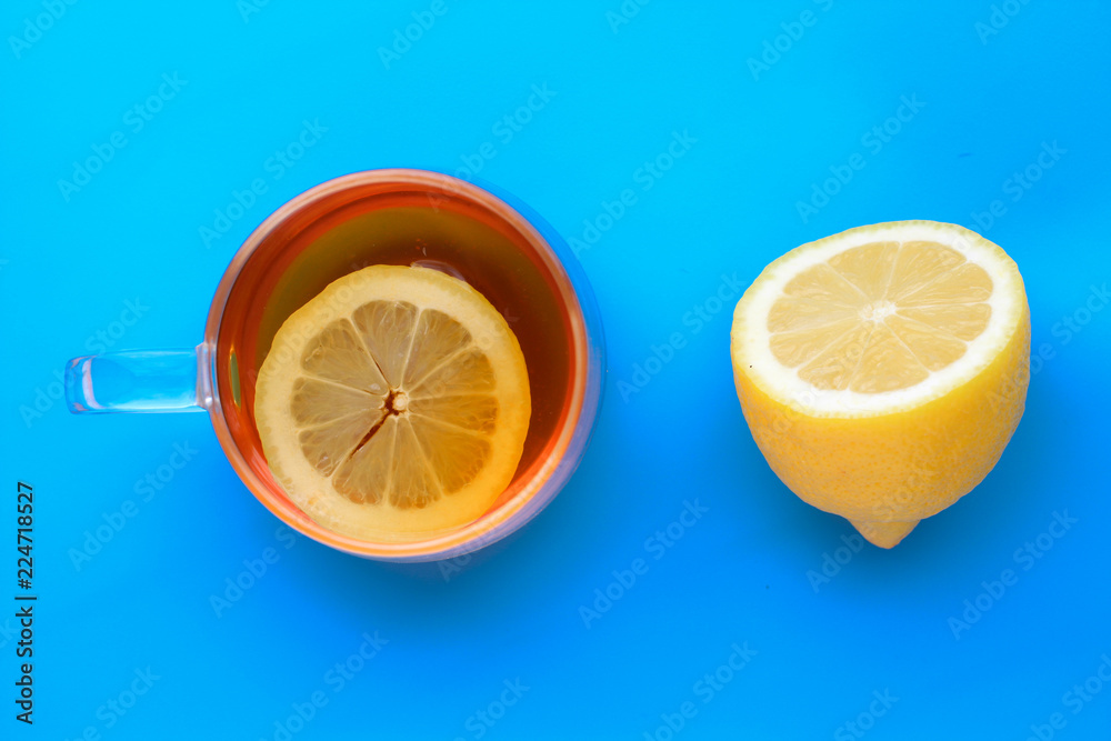 transparent Cup of tea with lemon, Freshly cut half lemon on blue background transparent Cup of tea with lemon, Freshly cut half lemon on blue background