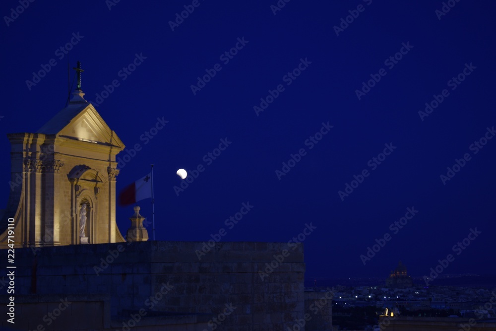 Blood moon by a church on Malta