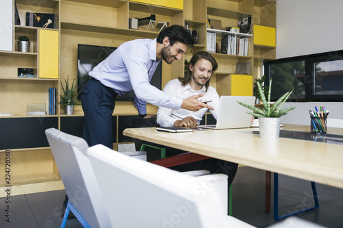 Two young businessmen worki...