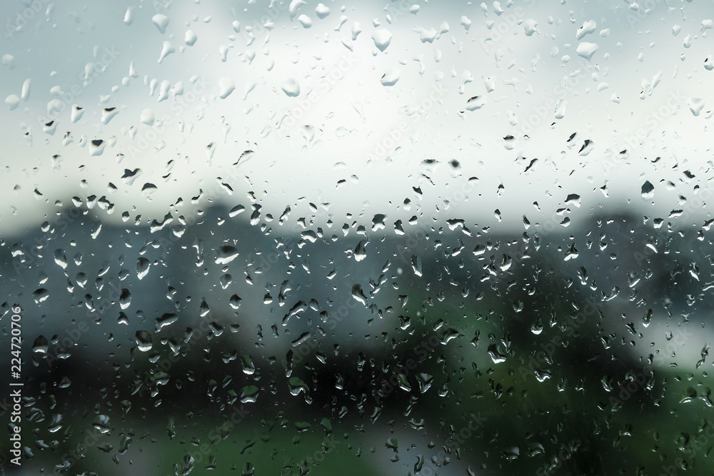 Creative background, drops on the glass, rain, view from the window in rainy weather. The concept of a bad mood, sadness.