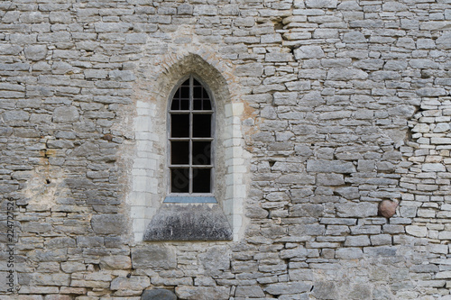 Window in the stone wall of an ancient monastery destroyed during the Livonian War in the Middle Ages © Anton