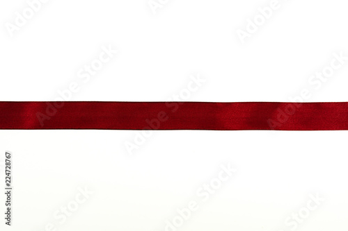 Red fabric ribbon isolated on white background.