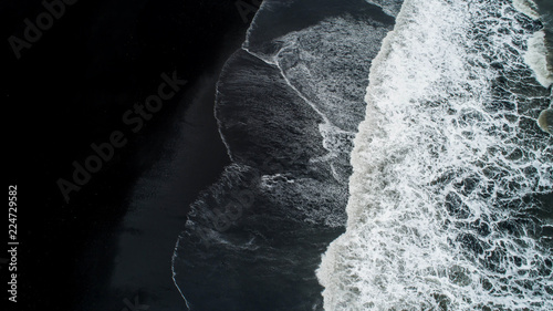 The black sand beach in Iceland. Sea aerial view and top view. Amazing nature, beautiful backgrounds and colors.