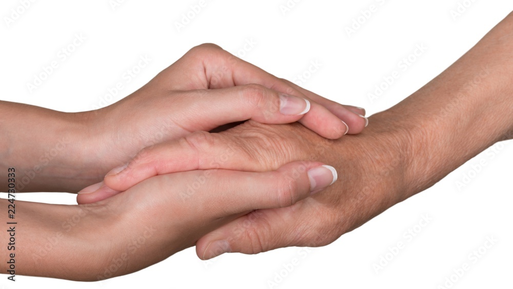 Young Woman's Hands Touching and Holding an Old Woman's Hand Young Woman's Hands Touching and Holding an Old Woman's Hand