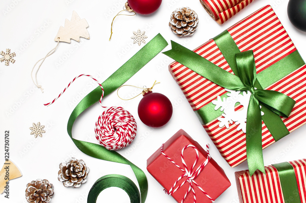 Fototapeta premium Gift boxes, Christmas balls, toys, fir cones, ribbon on white background. Festive, congratulation, New Year Christmas presents Xmas holiday 2019 greeting card. Flat lay, top view, copy space.