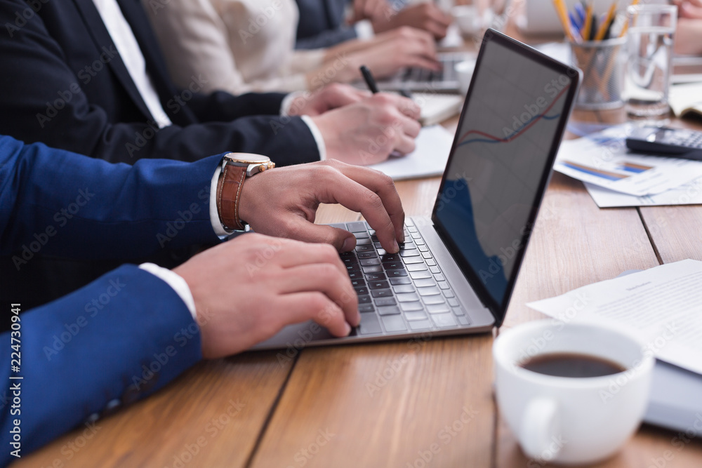 Businessman hands typing on laptop during meeting Businessman hands typing on laptop during meeting