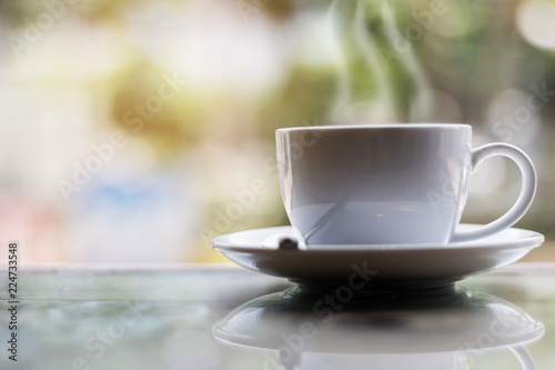 Hot coffee on table in bokeh background